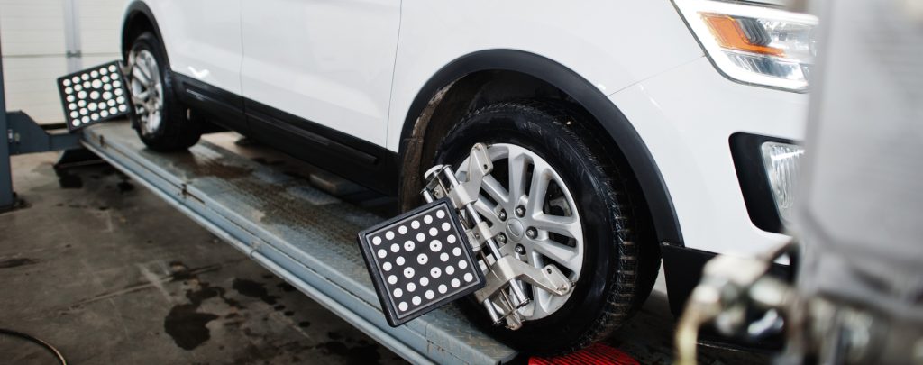 Car on a ramp having its wheels aligned - Wheel Alignment Worthing
